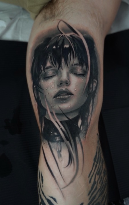 Black and grey portrait of a woman with wet hair and a studded collar, eyes closed.